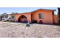 View of the single-story home featuring desert landscaping with rock features and an arched entryway at 4623 W Mission Ln, Glendale, AZ 85302