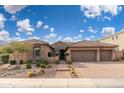 Charming single-Gathering home featuring lush landscaping, a stone facade, and a three-car garage at 5428 E Windstone Trl, Cave Creek, AZ 85331