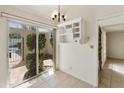 Dining area with sliding glass doors to a courtyard and built-in shelving at 5622 N Palacio Way, Phoenix, AZ 85014