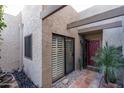 Inviting entryway featuring a red front door, tiled walkway, and lush desert landscaping at 5637 N 78Th Way, Scottsdale, AZ 85250