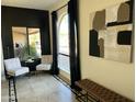 Bright sitting area with neutral furniture, black accent wall, and view to the exterior at 6819 E Sheena Dr, Scottsdale, AZ 85254