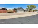 Exterior view of a well-maintained home with a three-car garage and low-maintenance landscaping at 8942 W Peck Dr, Glendale, AZ 85305