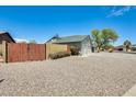 Exterior showcasing an attached three-car garage and a pergola-covered porch at 8942 W Peck Dr, Glendale, AZ 85305