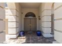 Inviting front entrance featuring double doors, decorative columns, and elegant lighting fixtures at 9548 W Keyser Dr, Peoria, AZ 85383