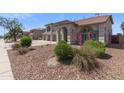 A well-maintained lawn with beautiful landscaping frames this attractive single-Gathering home at 9548 W Keyser Dr, Peoria, AZ 85383
