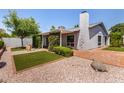 Private backyard oasis featuring manicured landscaping, including grass and gravel areas at 9636 N 53Rd Ave, Glendale, AZ 85302