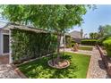 Beautifully landscaped backyard showcasing mature trees and manicured hedges at 9636 N 53Rd Ave, Glendale, AZ 85302