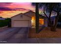 Single-story home featuring desert landscaping, a two-car garage and classic southwestern architecture at 10735 W Bermuda Dr, Avondale, AZ 85392