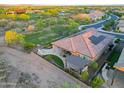 Spacious backyard with a covered patio, outdoor kitchen, fire pit and mountain views at 13236 W Montansoro Ln, Peoria, AZ 85383