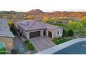 Home with a three-car garage, desert landscaping, and mountain views at 13236 W Montansoro Ln, Peoria, AZ 85383