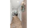 Open entryway with wood-look flooring, wreath, and view into the living space at 14435 W El Cortez Pl, Surprise, AZ 85387