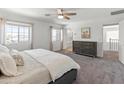 Spacious main bedroom with carpeting, windows and entry to bathroom at 14435 W El Cortez Pl, Surprise, AZ 85387