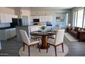 Stylish dining area featuring a modern table with seating for four, adjacent to the kitchen at 18174 E Via Jardin --, Gold Canyon, AZ 85118