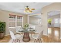 Dining area with glass table set for four, great lighting, and view to the exterior at 201 S Greenfield Rd # 173, Mesa, AZ 85206