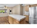Kitchen with island, stainless appliances, and views to the dining and living area at 201 S Greenfield Rd # 173, Mesa, AZ 85206