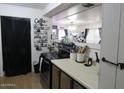 Functional kitchen featuring laminated countertops and upper and lower cabinets that maximize space for meal preparation at 2359 S Tomahawk Rd, Apache Junction, AZ 85119