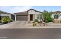 Charming home featuring stone accents, a two-car garage, and well-maintained landscaping at 27510 N 30Th Ln, Phoenix, AZ 85083
