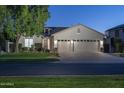 Charming home with a three-car garage, mature trees, and a well-manicured lawn showcases curb appeal at 3237 E Park Ave, Gilbert, AZ 85234