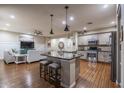 Open concept kitchen with center island, stainless steel appliances, and hardwood floors create a seamless living space at 3237 E Park Ave, Gilbert, AZ 85234