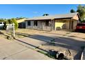 View of single story home with carport and driveway on a sunny day at 3701 E Karen Dr, Phoenix, AZ 85032