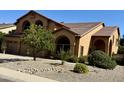 Landscaped desert-style yard with mature trees and shrubbery in front of a two-story home at 4018 E Adobe Dr, Phoenix, AZ 85050