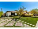 A manicured front yard featuring a lush lawn, manicured hedges, and unique pavers, leading to the home at 4021 E Glenrosa Ave, Phoenix, AZ 85018