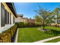 Lush green backyard featuring an outdoor brick fireplace and manicured landscaping at 4021 E Glenrosa Ave, Phoenix, AZ 85018