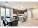 Open-concept kitchen with stainless steel appliances, a large island, and adjacent dining area at 4046 S 58Th Ln, Phoenix, AZ 85043