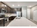 Modern kitchen boasting stainless steel appliances, a large island, and sleek, dark cabinetry at 4046 S 58Th Ln, Phoenix, AZ 85043