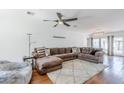Inviting living area showcasing a large sectional, soft rug, and stylish ceiling fan at 4402 E Montecito Ave, Phoenix, AZ 85018