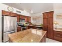 Well-equipped kitchen with stainless steel appliances and a large center island with granite countertops at 4441 E Desert Wind Dr, Phoenix, AZ 85044