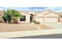 Charming single-story home with a well-manicured desert landscape and a two-car garage at 4628 W Whispering Wind Dr, Glendale, AZ 85310