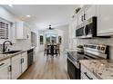Bright kitchen with stainless appliances, marble counters and eat-in breakfast nook at 4712 E Lone Cactus Dr, Phoenix, AZ 85050