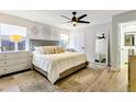 Calming main bedroom with neutral colors, tray ceiling, and ceiling fan at 4712 E Lone Cactus Dr, Phoenix, AZ 85050