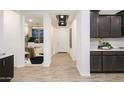 Inviting hallway features modern lighting and seamlessly connects the kitchen to the office at 4920 W Walatowa St, Laveen, AZ 85339