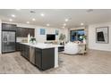 Open-concept living room and kitchen area with sleek appliances and stylish design at 4920 W Walatowa St, Laveen, AZ 85339