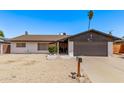Charming single-story home features low maintenance landscaping, painted brick, and a two-car garage at 5226 W Redfield Rd, Glendale, AZ 85306