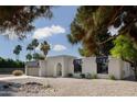 Eye-catching single-story home featuring desert landscaping, and modern architectural details at 5341 E Sheena Dr, Scottsdale, AZ 85254