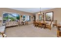 Well-lit living room and dining area with views of the private backyard at 6133 W Fetlock Ter, Phoenix, AZ 85083
