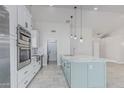 Bright kitchen features updated appliances, ample storage, and a center island with stylish countertops at 676 W Shawnee Dr, Chandler, AZ 85225