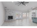 Bright living room with a fireplace, updated tile floors, and double doors to the backyard at 676 W Shawnee Dr, Chandler, AZ 85225