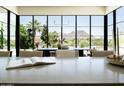 Bright dining area showcasing floor-to-ceiling windows with picturesque mountain scenery at 7215 N Black Rock Trl, Paradise Valley, AZ 85253