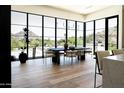 Elegant dining room featuring floor-to-ceiling windows with scenic views and hardwood floors at 7215 N Black Rock Trl, Paradise Valley, AZ 85253