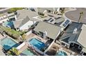Aerial shot showcasing the backyard pool, lush landscaping, and solar panels on the roof at 7536 W Sequoia Dr, Glendale, AZ 85308