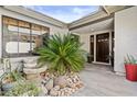 Inviting entryway featuring a garden, tiled walkway, and a double-door entrance at 7536 W Sequoia Dr, Glendale, AZ 85308