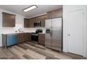 Updated kitchen with stainless steel appliances, white countertops, and sleek wood-look floors at 7801 N 44Th Dr # 1003, Glendale, AZ 85301
