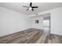 Open living room boasts wood-look floors and a ceiling fan, creating a comfortable space at 7801 N 44Th Dr # 1003, Glendale, AZ 85301