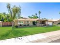 Inviting single-Gathering home with lush green lawn and a charming, covered entryway at 7802 N 6Th St, Phoenix, AZ 85020