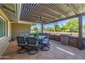 Relaxing covered patio with outdoor dining set and brick accents at 7802 N 6Th St, Phoenix, AZ 85020