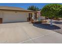 Charming single-story home featuring an attached two-car garage, brick accents, and a welcoming front patio at 8160 E Keats Ave # 364, Mesa, AZ 85209